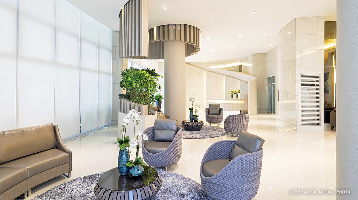 grace residences white lobby with blue chairs