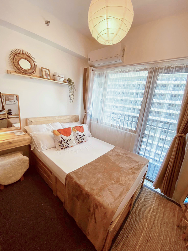 cozy bed by the window in SMDC Fame Residences