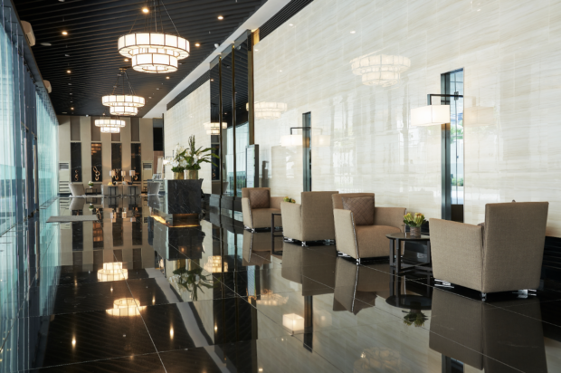 air residences lobby with shiny floors and chandeliers 